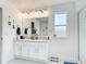 Bathroom with double vanity, granite countertops, and plenty of space, for luxurious feel at 511 Preserve Pointe Blvd, Davenport, FL 33837