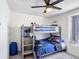 ' bedroom featuring a grey bunk bed with colorful bedding and a ceiling fan at 511 Preserve Pointe Blvd, Davenport, FL 33837