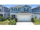 Charming two-story home featuring a two-car garage, covered entry, and well-maintained landscaping at 511 Preserve Pointe Blvd, Davenport, FL 33837