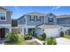 Inviting two-story home with a two-car garage, charming landscaping, and covered front entry at 511 Preserve Pointe Blvd, Davenport, FL 33837