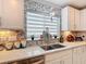 Beautiful kitchen featuring granite countertops, stylish backsplash, and stainless steel sink at 511 Preserve Pointe Blvd, Davenport, FL 33837