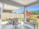 Covered patio with seating and a view of the backyard with a playground at 511 Preserve Pointe Blvd, Davenport, FL 33837