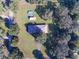 Overhead view of a well-maintained home featuring a backyard pool, set on a spacious lot with lush greenery at 5121 Shady Oak S Dr, Lakeland, FL 33810