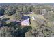 Aerial view of a single Gathering home with a pool surrounded by lush trees at 5121 Shady Oak S Dr, Lakeland, FL 33810