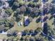 Aerial shot of a charming residence with a pool and surrounding trees, providing a peaceful and secluded atmosphere at 5121 Shady Oak S Dr, Lakeland, FL 33810