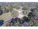 Aerial view of a single Gathering home with a pool surrounded by lush trees at 5121 Shady Oak S Dr, Lakeland, FL 33810