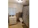 Bathroom with white vanity, toilet, shower with shower curtain and a window at 5121 Shady Oak S Dr, Lakeland, FL 33810