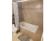 Bathroom featuring a toilet, tub, and decorative shower curtain, with warm tile throughout at 5121 Shady Oak S Dr, Lakeland, FL 33810