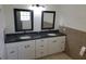 Bathroom with double sink vanity with marble countertop and updated mirrors and lighting at 5121 Shady Oak S Dr, Lakeland, FL 33810