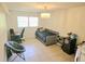 Bedroom includes a chandelier, a window, tile flooring, and modern decor at 5121 Shady Oak S Dr, Lakeland, FL 33810
