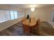 Bright dining room with chandelier lighting, wood flooring, and a large window at 5121 Shady Oak S Dr, Lakeland, FL 33810