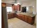 Spacious kitchen featuring granite countertops, stainless steel appliances, and dark wood cabinets at 5121 Shady Oak S Dr, Lakeland, FL 33810