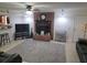Spacious living room featuring a brick fireplace, neutral tile flooring and a ceiling fan at 5121 Shady Oak S Dr, Lakeland, FL 33810