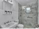 Bright bathroom featuring a glass enclosed shower and marble tile at 516 Windsor St, Lakeland, FL 33803