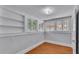 Small bedroom showcasing hardwood floors, several windows, and built-in shelves at 516 Windsor St, Lakeland, FL 33803