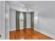 Clean bedroom with wood floors, a ceiling fan, and large windows at 516 Windsor St, Lakeland, FL 33803