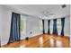Bright, spacious bedroom features hardwood floors, neutral walls and large window with curtains at 516 Windsor St, Lakeland, FL 33803