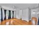 Bright bedroom features hardwood floors, a ceiling fan, neutral walls and a window with curtains at 516 Windsor St, Lakeland, FL 33803