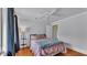 Bedroom boasting a ceiling fan, hardwood floors, neutral walls, and a pink bed at 516 Windsor St, Lakeland, FL 33803