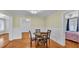 Dining room featuring hardwood floors, white wainscoting, and a view into another room at 516 Windsor St, Lakeland, FL 33803