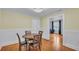 Dining room featuring hardwood floors, neutral walls, and a view into the living room at 516 Windsor St, Lakeland, FL 33803