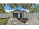 Detached one-car garage featuring a fenced yard with mulch ground cover at 516 Windsor St, Lakeland, FL 33803