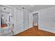Hallway featuring a bathroom entrance and hardwood floors, leading to other rooms at 516 Windsor St, Lakeland, FL 33803