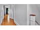 Hallway with wood floors leads to another room, providing a clear path through the house at 516 Windsor St, Lakeland, FL 33803