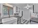 Kitchen featuring stainless steel dishwasher, farmhouse sink, and an entry to the bathroom at 516 Windsor St, Lakeland, FL 33803