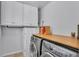 Bright laundry room with appliances and built-in cabinet at 516 Windsor St, Lakeland, FL 33803