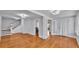 Bright living room with hardwood floors, staircase, and French doors to another room at 516 Windsor St, Lakeland, FL 33803
