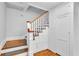 Stairway features wooden stairs with white risers, a white handrail, and storage at 516 Windsor St, Lakeland, FL 33803