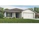 Charming single-story home with a two-car garage, well-manicured lawn, and classic architectural details at 5393 Se 129Th Ln, Belleview, FL 34420