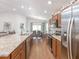 Spacious kitchen featuring stainless steel appliances, granite countertops, and a view of the dining area at 5393 Se 129Th Ln, Belleview, FL 34420
