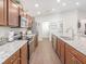 Modern kitchen with stainless steel appliances, granite countertops, and wooden cabinets at 5393 Se 129Th Ln, Belleview, FL 34420