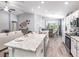 Spacious open-concept kitchen with a large island, modern appliances, seamlessly connected to the dining and living areas at 5424 Se 127Th Ln, Belleview, FL 34420