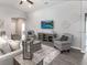 Comfortable living room showcasing neutral tones, elegant wall decor, and cozy seating, ideal for relaxation and entertainment at 5424 Se 127Th Ln, Belleview, FL 34420