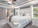 Spacious main bedroom featuring a decorative headboard, tray ceilings, and a tranquil ambiance at 5424 Se 127Th Ln, Belleview, FL 34420