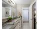 Bright bathroom featuring granite countertops, dual sinks, framed mirror and nearby shower at 5425 Charlin Ave, Lakeland, FL 33810