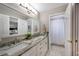 Bright bathroom features dual sinks with granite countertop, mirror, and shower at 5425 Charlin Ave, Lakeland, FL 33810