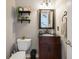 Charming half bath with modern vanity, decorative mirror, and floating shelves at 5425 Charlin Ave, Lakeland, FL 33810