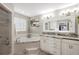 Bright bathroom featuring a soaking tub, large mirrors, double sinks, and recessed lighting, creating a luxurious space at 5425 Charlin Ave, Lakeland, FL 33810