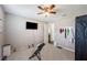 Well-lit bedroom with a ceiling fan, TV, dumbbells and an at-home sauna kit at 5425 Charlin Ave, Lakeland, FL 33810