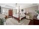 Spacious bedroom features a tray ceiling, and a four-poster bed with stylish decor, adding charm to the living space at 5425 Charlin Ave, Lakeland, FL 33810