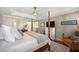 Bright bedroom features a four-poster bed, warm colors, and a large window, creating a cozy and inviting atmosphere at 5425 Charlin Ave, Lakeland, FL 33810