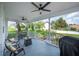 Outdoor covered patio with ceiling fans, seating, and a view of the manicured lawn at 5425 Charlin Ave, Lakeland, FL 33810
