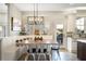 Bright dining area featuring a built-in bench, modern lighting, and easy access to the kitchen at 5425 Charlin Ave, Lakeland, FL 33810