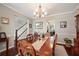 Traditional dining room with elegant chandelier and staircase view at 5425 Charlin Ave, Lakeland, FL 33810