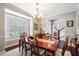 Charming dining room with bay window, hardwood floors, and staircase view at 5425 Charlin Ave, Lakeland, FL 33810