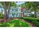 Beautiful two-story home with green shutters, surrounded by well-maintained landscaping and mature trees at 5425 Charlin Ave, Lakeland, FL 33810